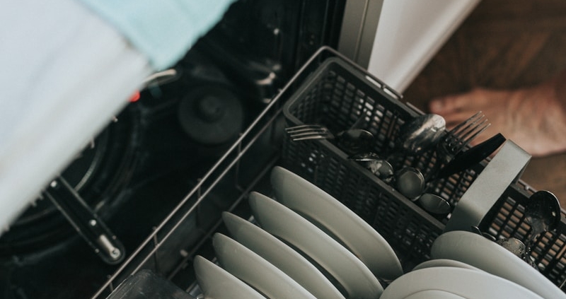 white ceramic plate on black dishwasher